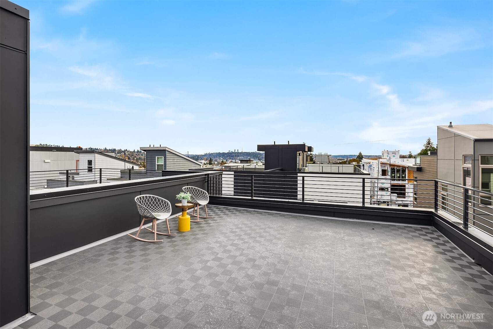 1514 Northwest 63rd Street, Unit B Seattle, WA 98107 - Photo 19 of 20 a view of roof deck with two chairs and a barbeque
