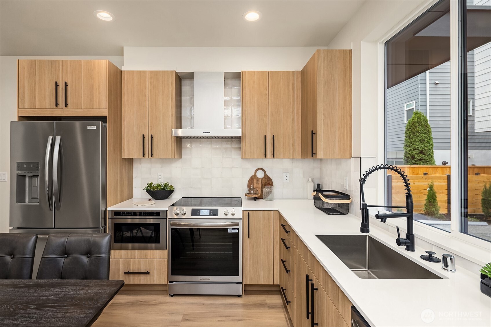 1514 Northwest 63rd Street, Unit B Seattle, WA 98107 - Photo 5 of 20 a kitchen with stainless steel appliances granite countertop a sink stove and refrigerator