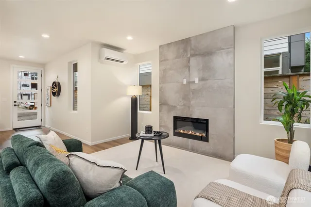 a living room with furniture a fireplace and a potted plant