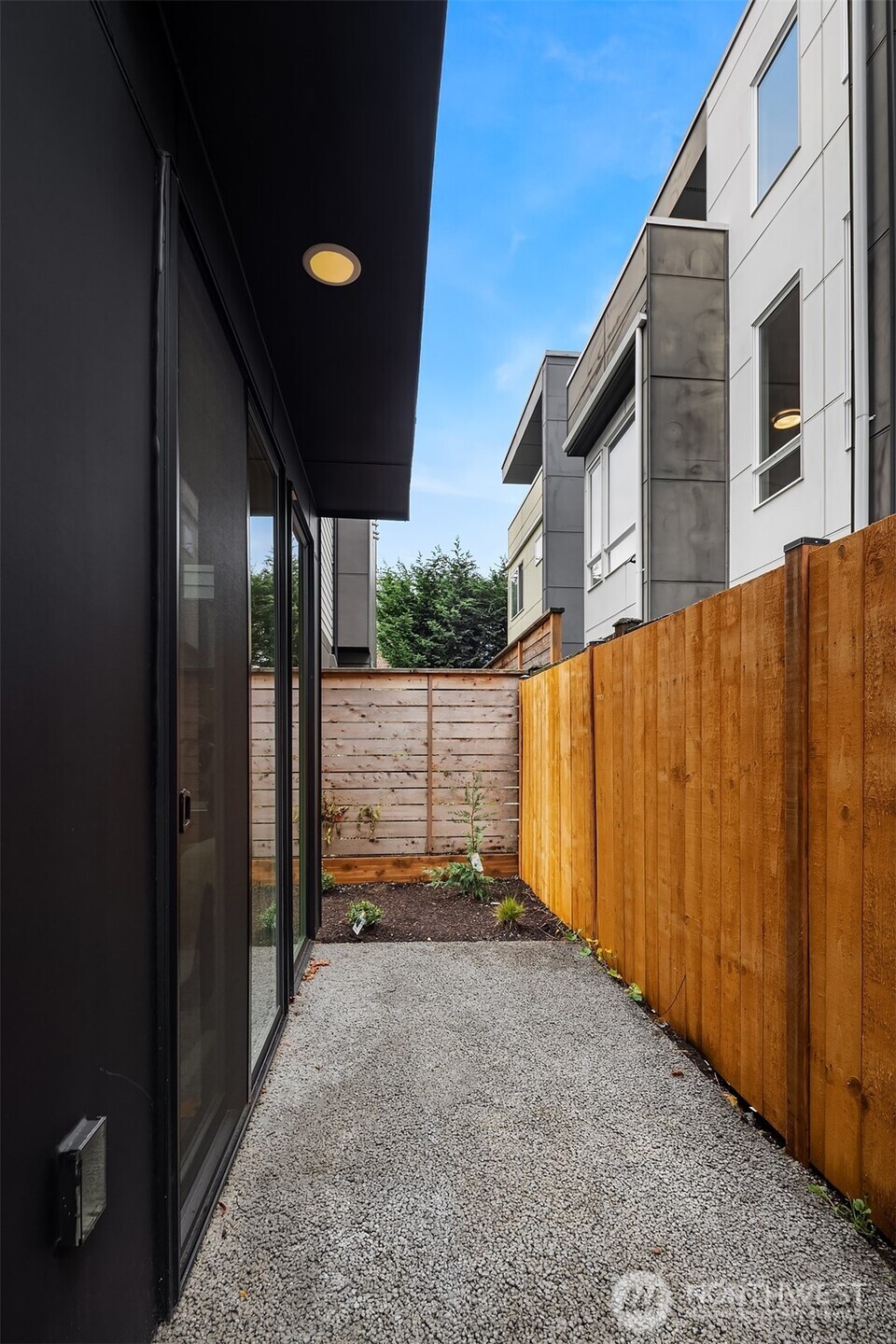1514 Northwest 63rd Street, Unit B Seattle, WA 98107 - Photo 9 of 20 a view of a house with backyard and wooden fence