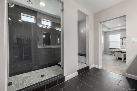 a bathroom with a glass shower door