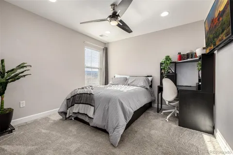 a bedroom with a bed and a potted plant