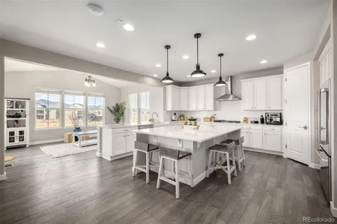 a large kitchen with a table and chairs in it