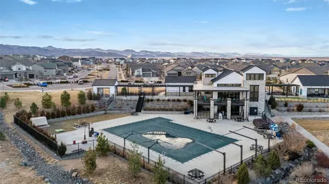 an aerial view of a house with a yard and mountain