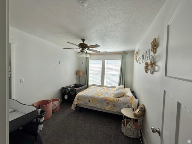 327 West Main Street, Unit 14 Santaquin, UT 84655 - Photo 12 of 20 Bedroom with a textured ceiling, dark colored carpet, and ceiling fan