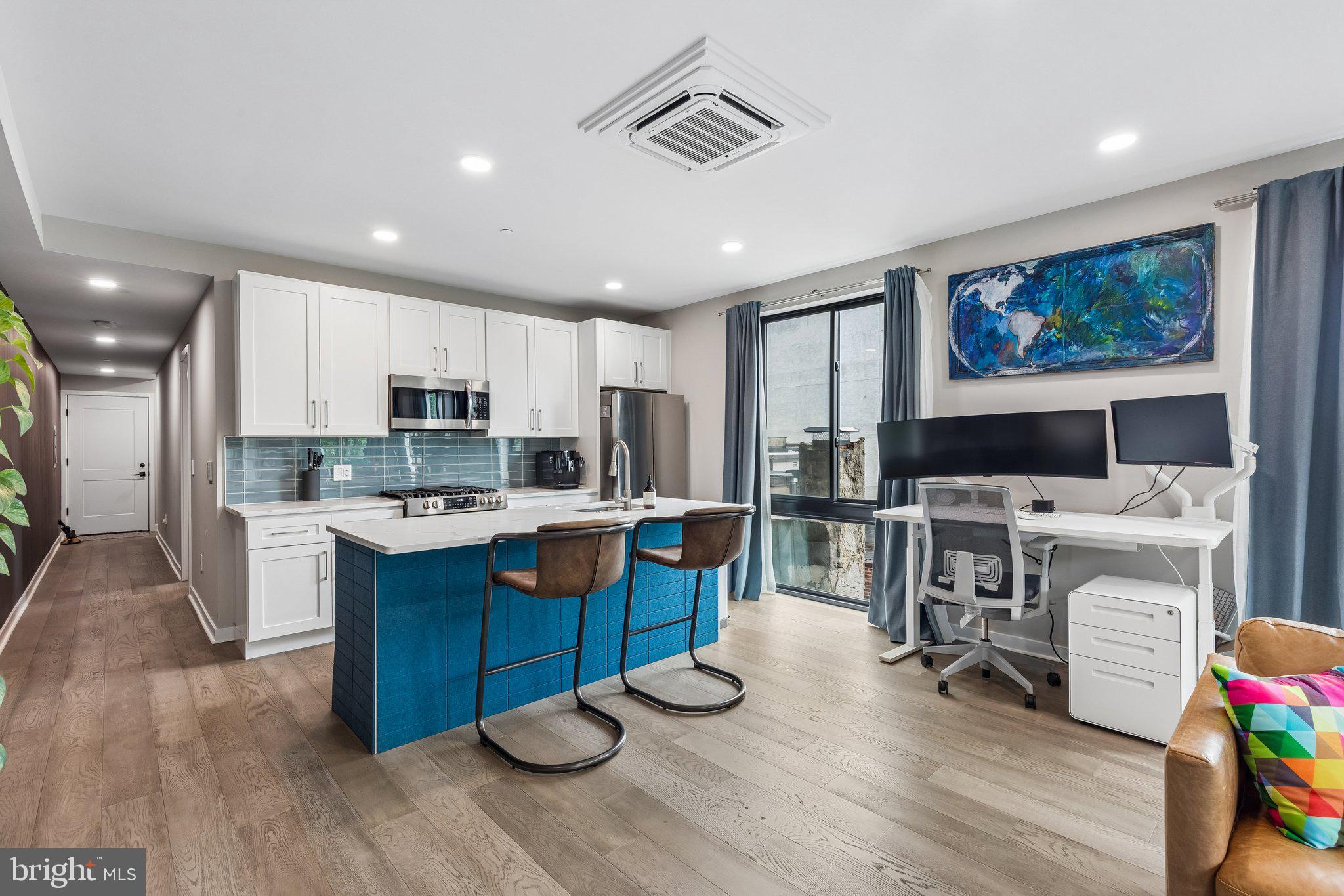 1648-50 Ridge Avenue, Unit 302 Philadelphia, PA 19130 - Photo 11 of 38 a living room with stainless steel appliances furniture and a flat screen tv
