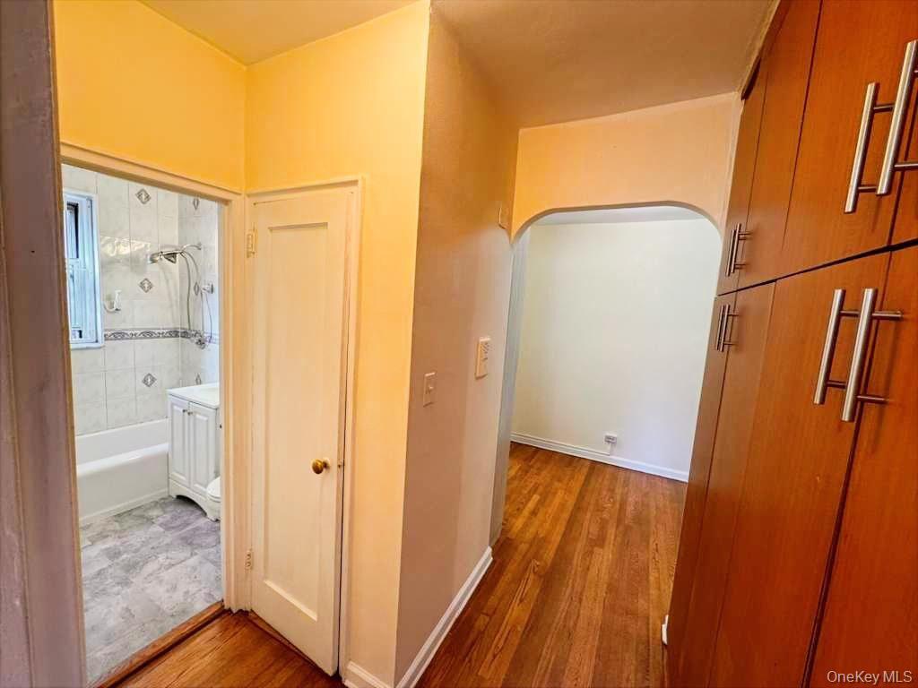 63-60 102nd Street, Unit A7 Queens, NY 11374 - Photo 11 of 15 a view of bedroom with bathroom and wooden floor