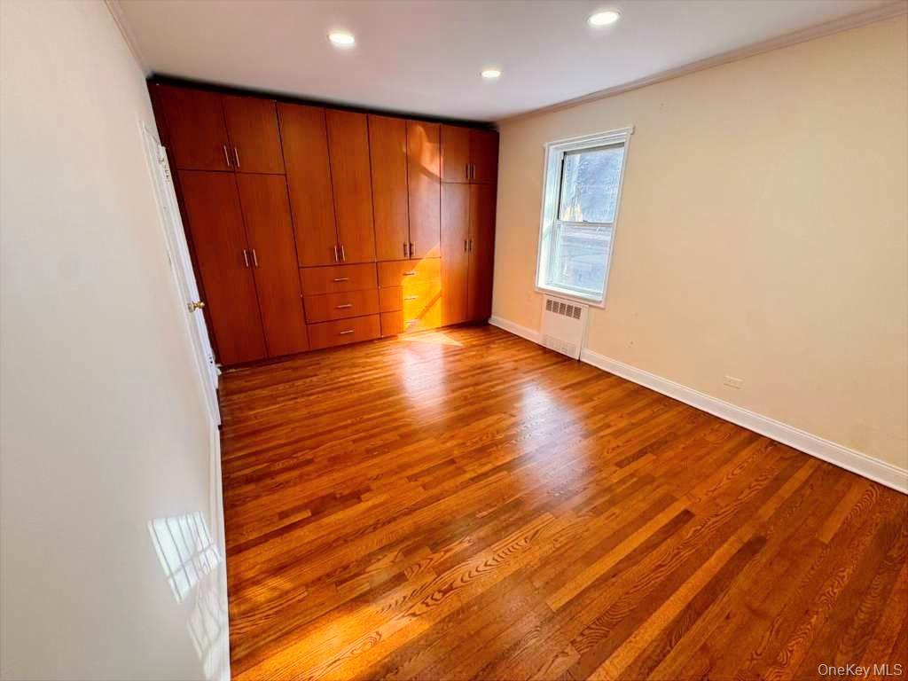 63-60 102nd Street, Unit A7 Queens, NY 11374 - Photo 12 of 15 a view of an empty room with wooden floor and a window