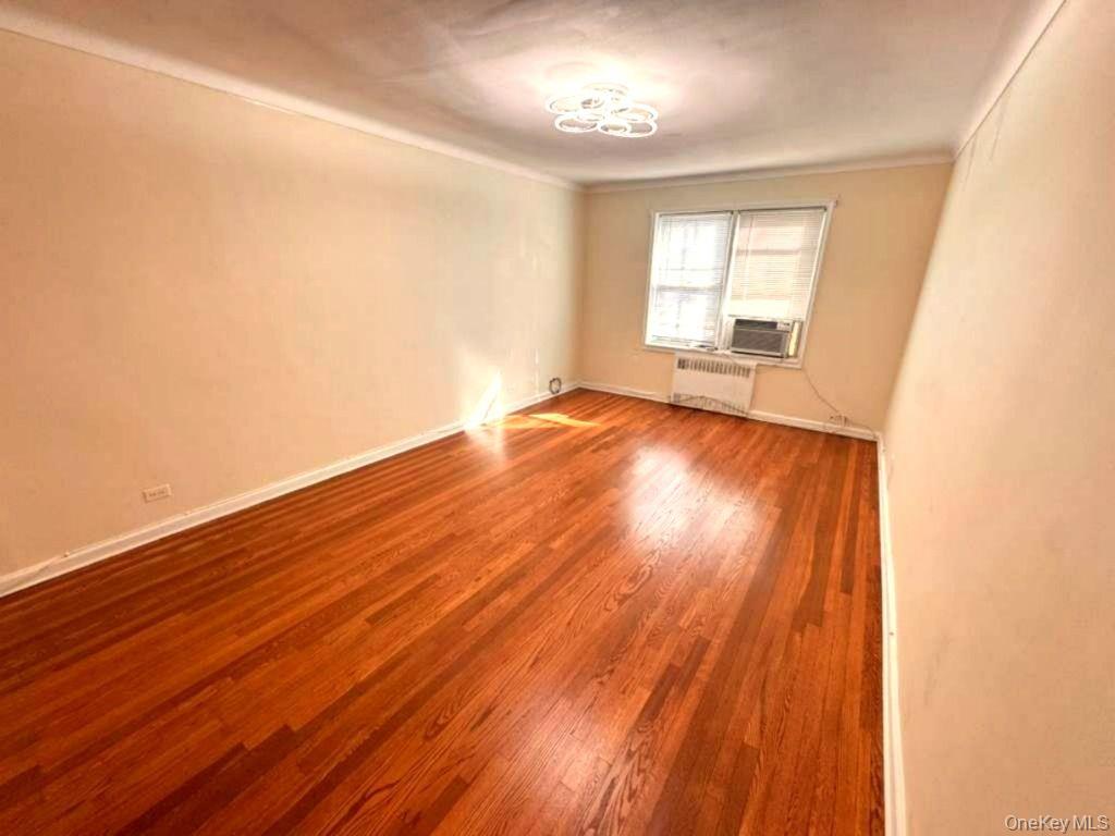 63-60 102nd Street, Unit A7 Queens, NY 11374 - Photo 2 of 15 wooden floor in an empty room with a window