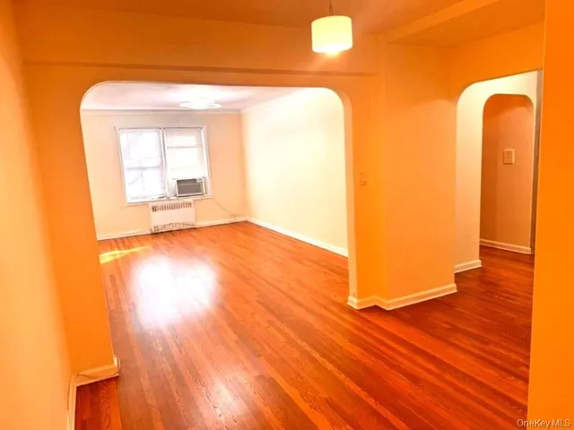 a view of a room with wooden floor