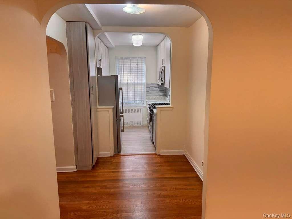 63-60 102nd Street, Unit A7 Queens, NY 11374 - Photo 4 of 15 a view of a hallway with wooden floor