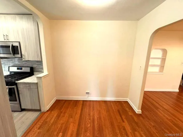 a view of a kitchen with wooden floor and a sink