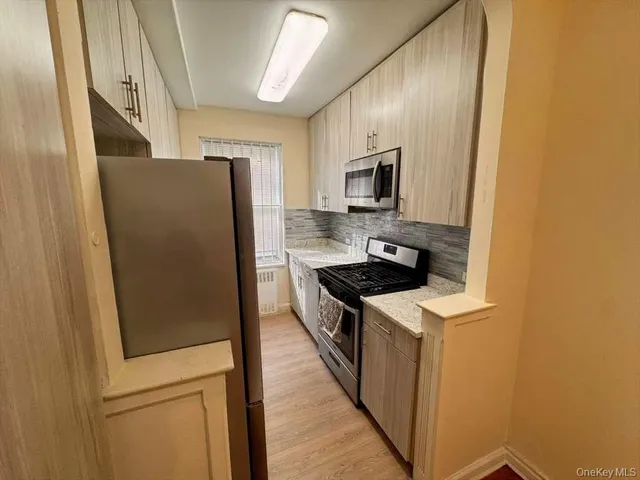 a kitchen with a refrigerator a stove and a sink