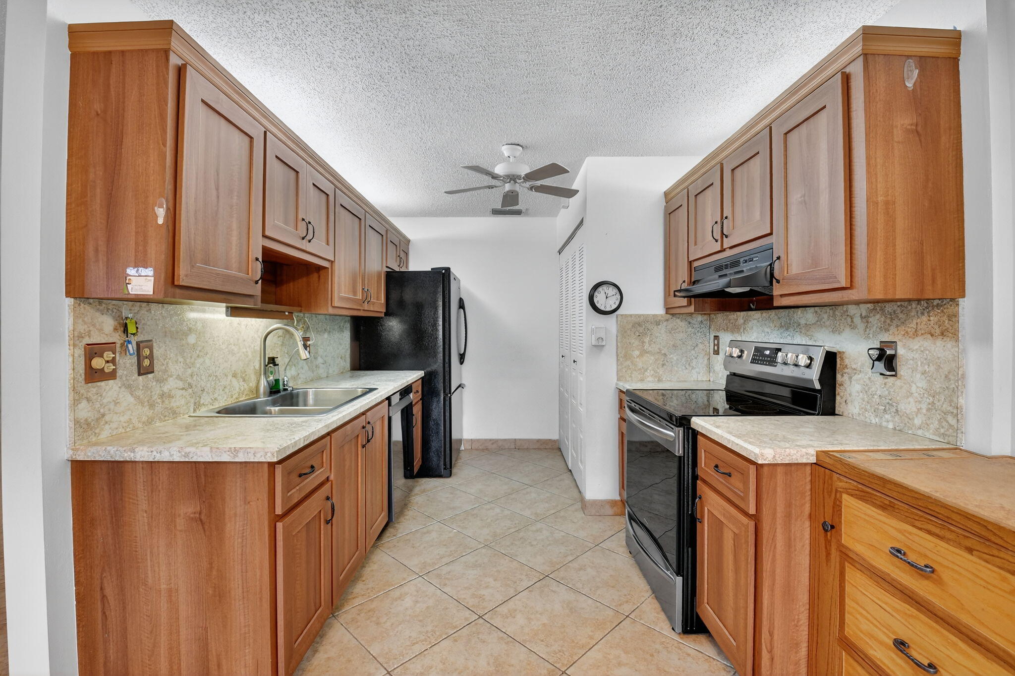 5775 Wanda Lane Delray Beach, FL 33484 - Photo 11 of 73 a kitchen with stainless steel appliances granite countertop a sink stove and refrigerator