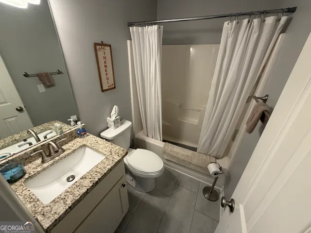 a view of a storage and utility room with wooden floor
