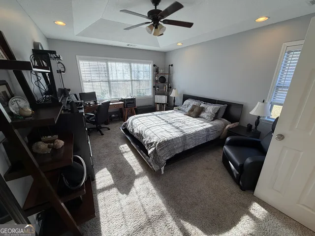 a bathroom with a granite countertop double vanity sink and mirror