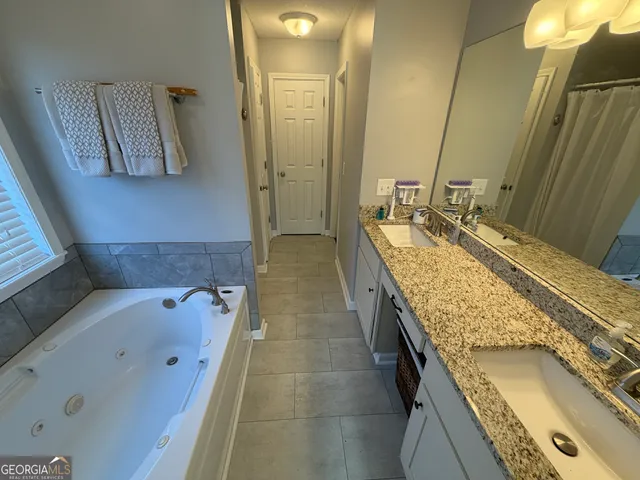 a kitchen with granite countertop a sink stainless steel appliances and cabinets