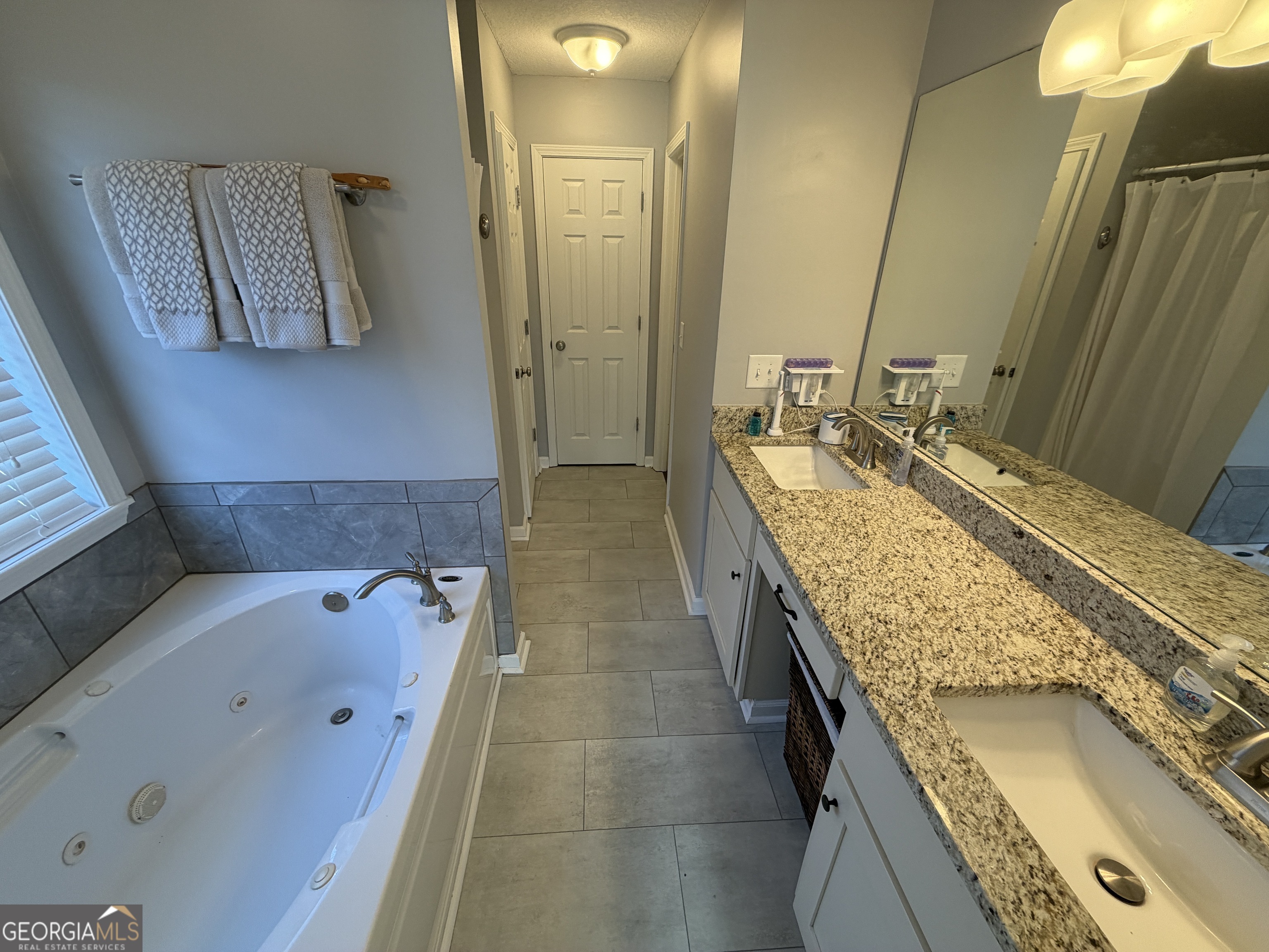 107 Westchester Circle Dublin, GA 31021 - Photo 18 of 22 a bathroom with a granite countertop double vanity sink and mirror
