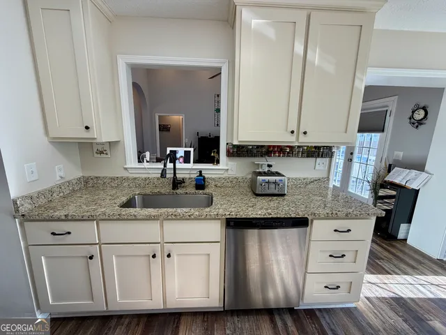 a kitchen with stainless steel appliances a refrigerator a stove and a microwave