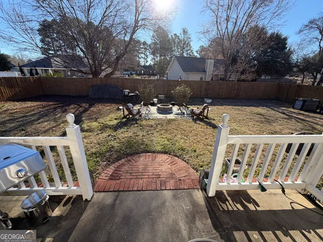 a view of a house with backyard and sitting area