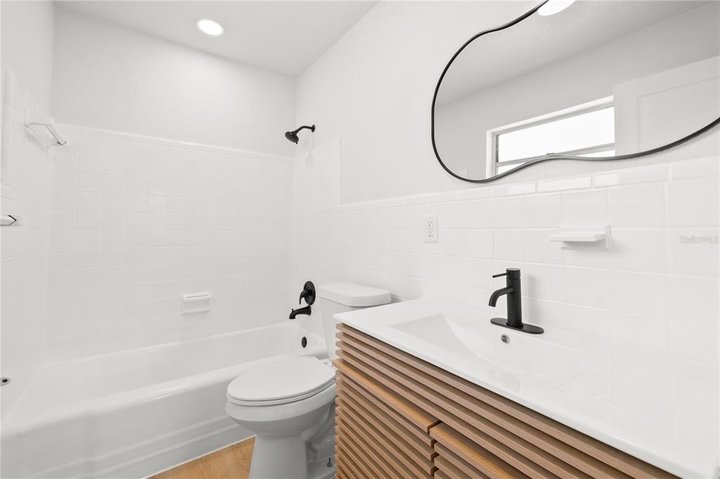 13388 1st Street East Madeira Beach, FL 33708 - Photo 10 of 28 a bathroom with a sink a toilet and a mirror
