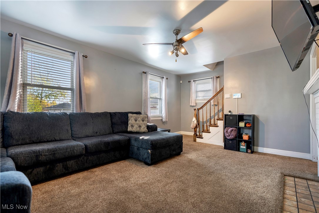1361 Crescent Road Southwest Canton, OH 44710 - Photo 5 of 36 Carpeted living room featuring stairway and a ceiling fan