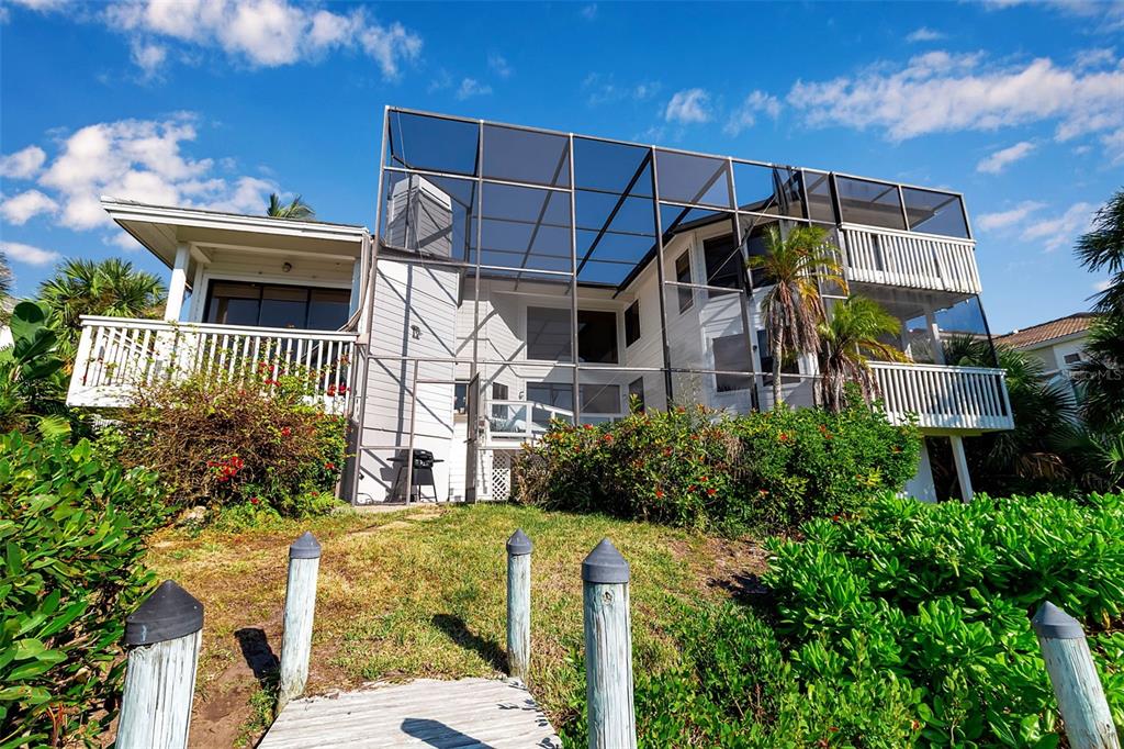 3361 Bayou Sound Longboat Key, FL 34228 - Photo 3 of 41 a front view of a house with garden