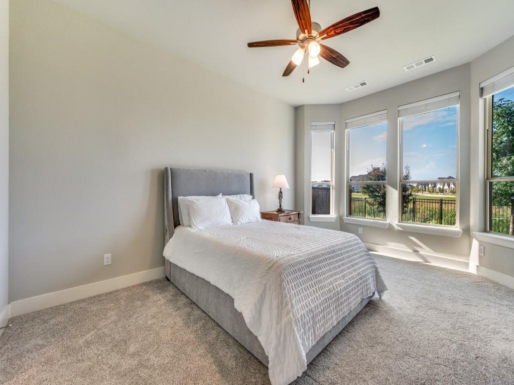 762 Corner Post Path Celina, TX 75009 - Photo 16 of 38 The primary bedroom features floor to ceiling windows with sweeping views of the backyard and lake.