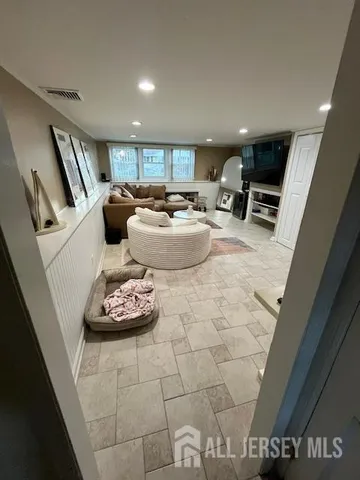 a living room with furniture and a flat screen tv