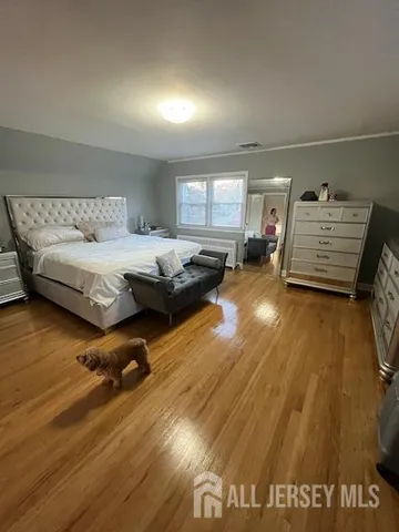 a large bed sitting in a large room next to a window