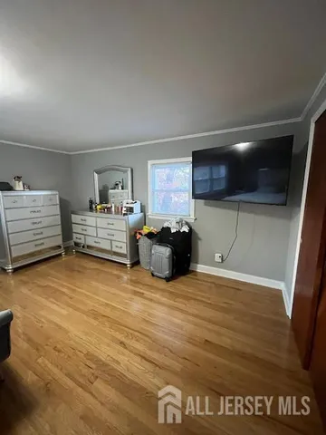 a view of a dining room with furniture a rug and wooden floor