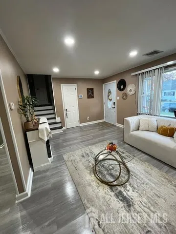 a living room with furniture and a flat screen tv