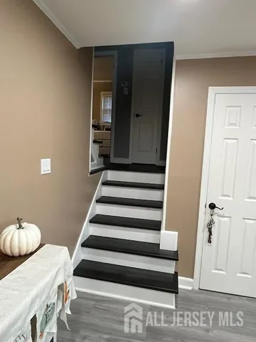 a view of a hallway with furniture and wooden floor
