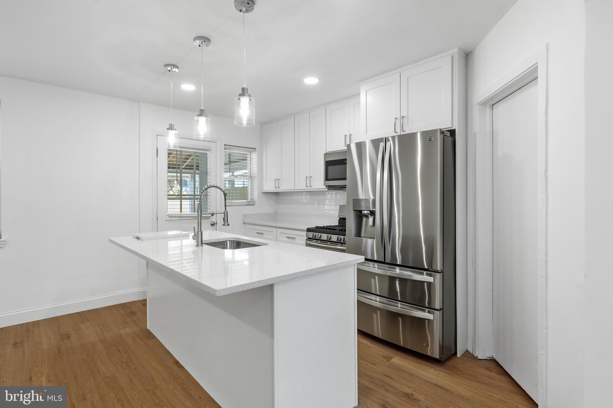 1714 Pin Oak Road Parkville, MD 21234 - Photo 13 of 41 Kitchen island w/ breakfast bar & quartz counters