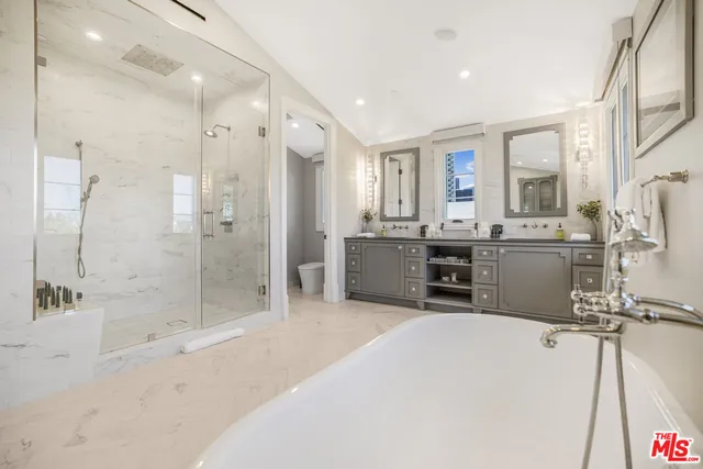 a kitchen with stainless steel appliances a refrigerator and a stove top oven