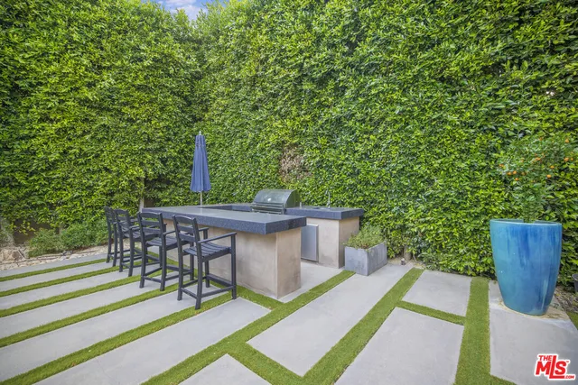 a view of house with backyard and furniture