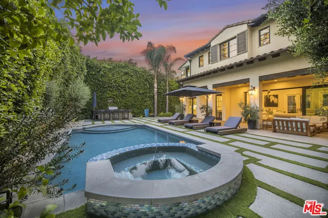 a view of a house with pool and sitting area