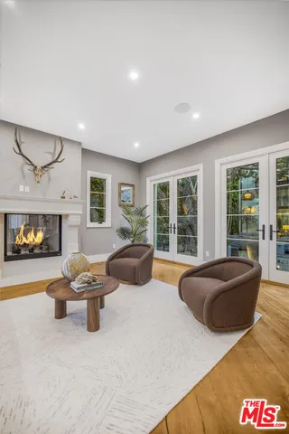 a large bedroom with furniture and a large window