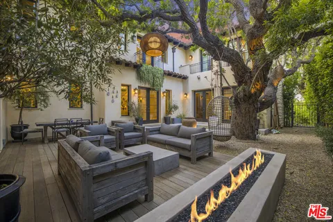 a view of a patio with couches and a fire pit