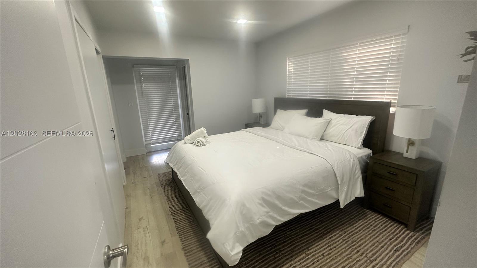 4290 Southwest 9th Street, Unit B Miami, FL 33134 - Photo 11 of 18 a bedroom with a bed and wooden floor