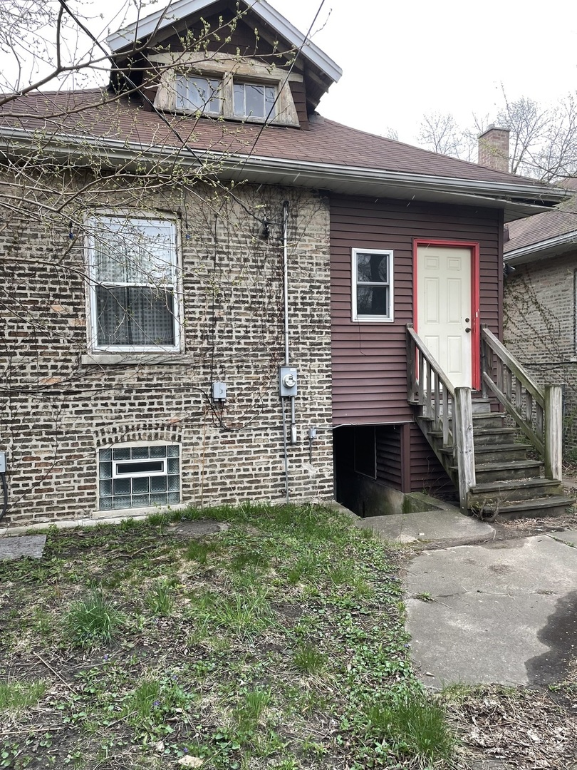 Undisclosed Address Chicago, IL 60617 - Photo 2 of 2 a front view of a house with a garden