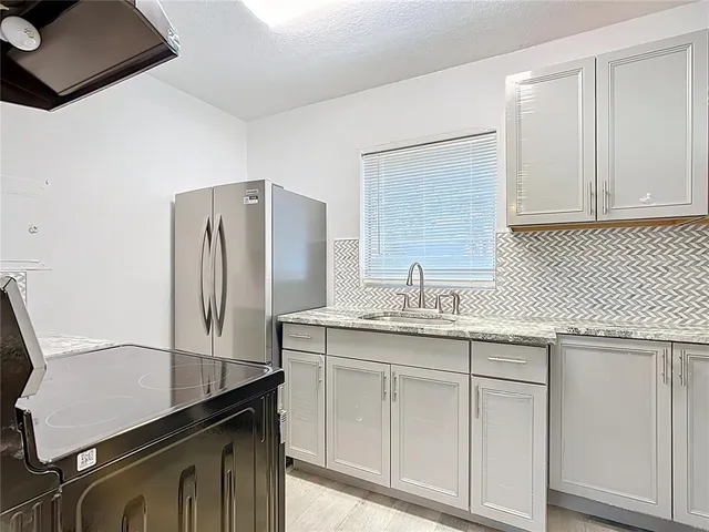 a kitchen with a sink and cabinets