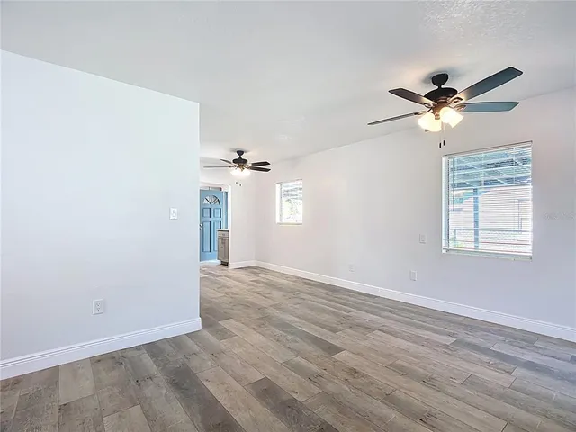 a view of a room with a ceiling fan and a window