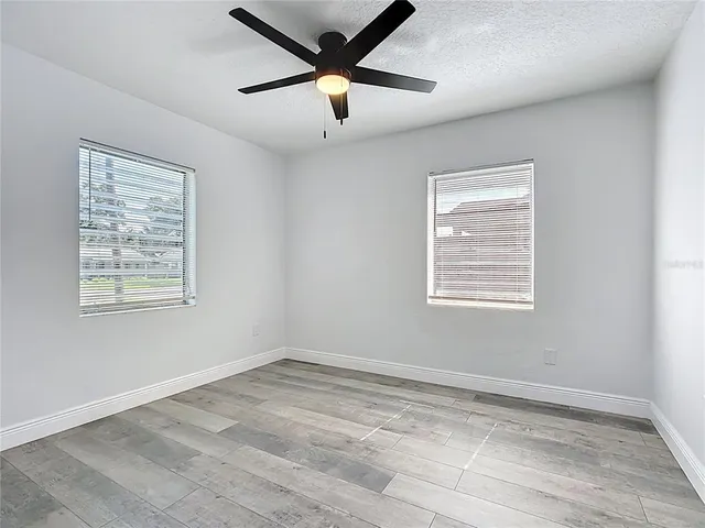 a view of a livingroom with a ceiling fan and window