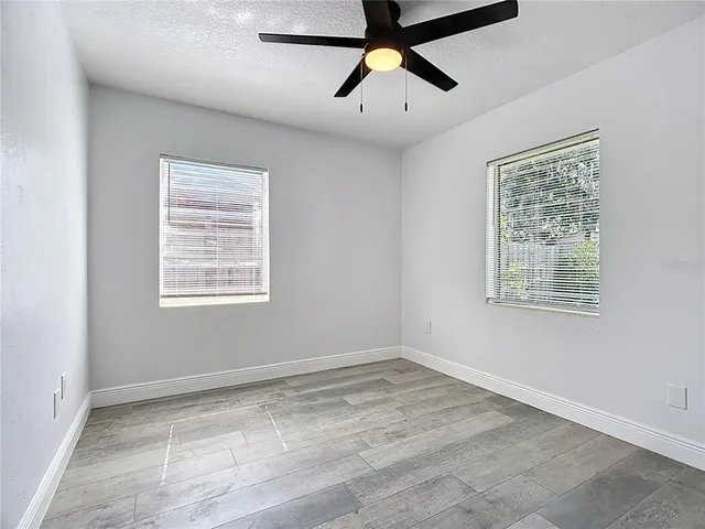 a view of room with hardwood floor and window