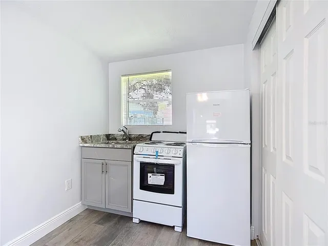 a kitchen with a stove top oven and sink