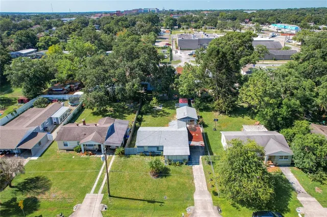 an aerial view of house with yard swimming pool and outdoor seating