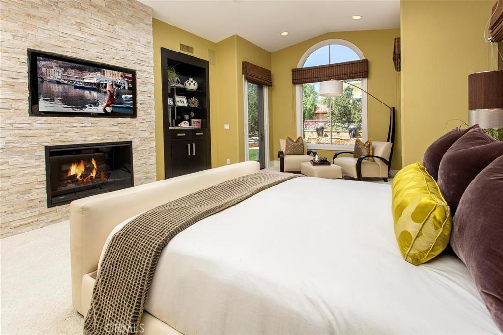 2395 Horizon Way Tustin, CA 92782 - Photo 21 of 43 a spacious bedroom with a bed and a fireplace