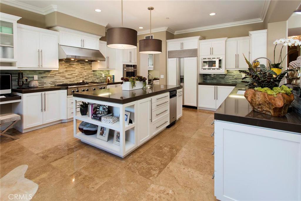 2395 Horizon Way Tustin, CA 92782 - Photo 8 of 43 a kitchen with stainless steel appliances granite countertop a stove top oven a sink a refrigerator and white cabinets