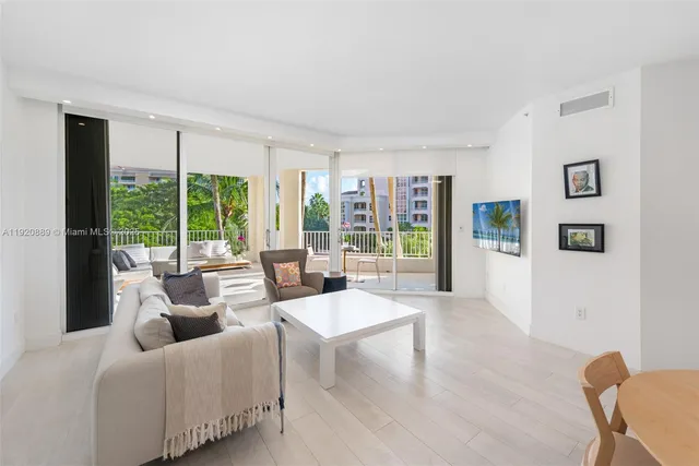 a living room with furniture and large windows
